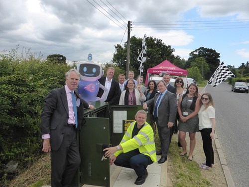 super sam with people by a green cabinet